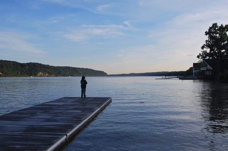 Angler fishing from a dock on the Hudson River in New York at dusk