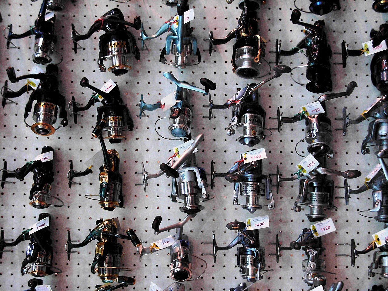 Rows of fishing reels on display in a tackle shop