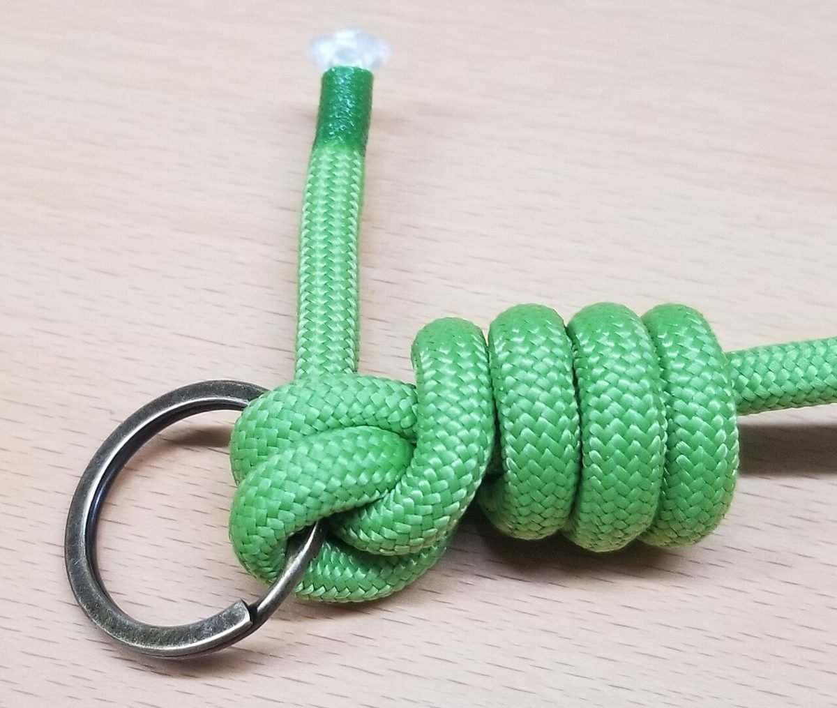 Trilene knot tied through a ring, shown with thick cord for clarity